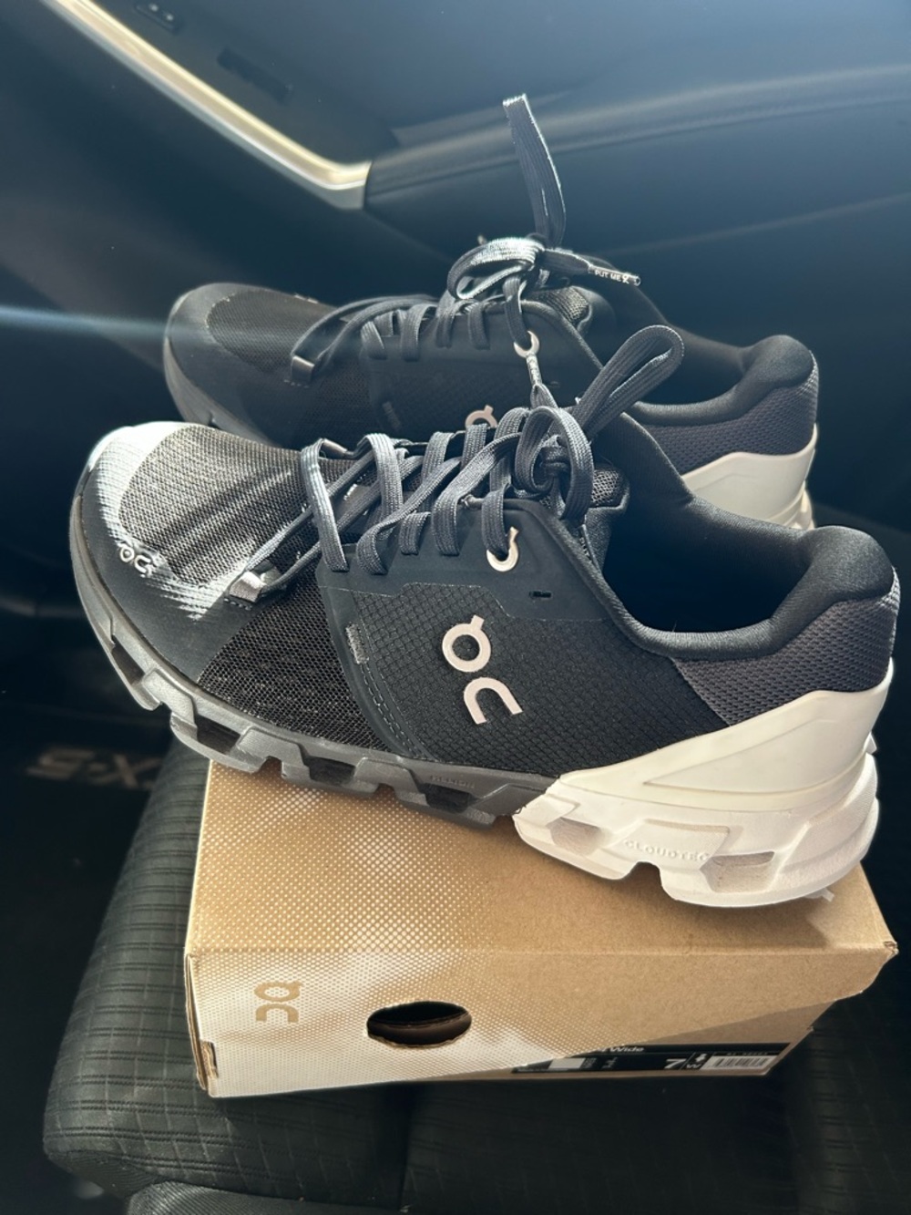 On Cloudflyer 4 Running Black and White Cloudventure Trail Sneakers